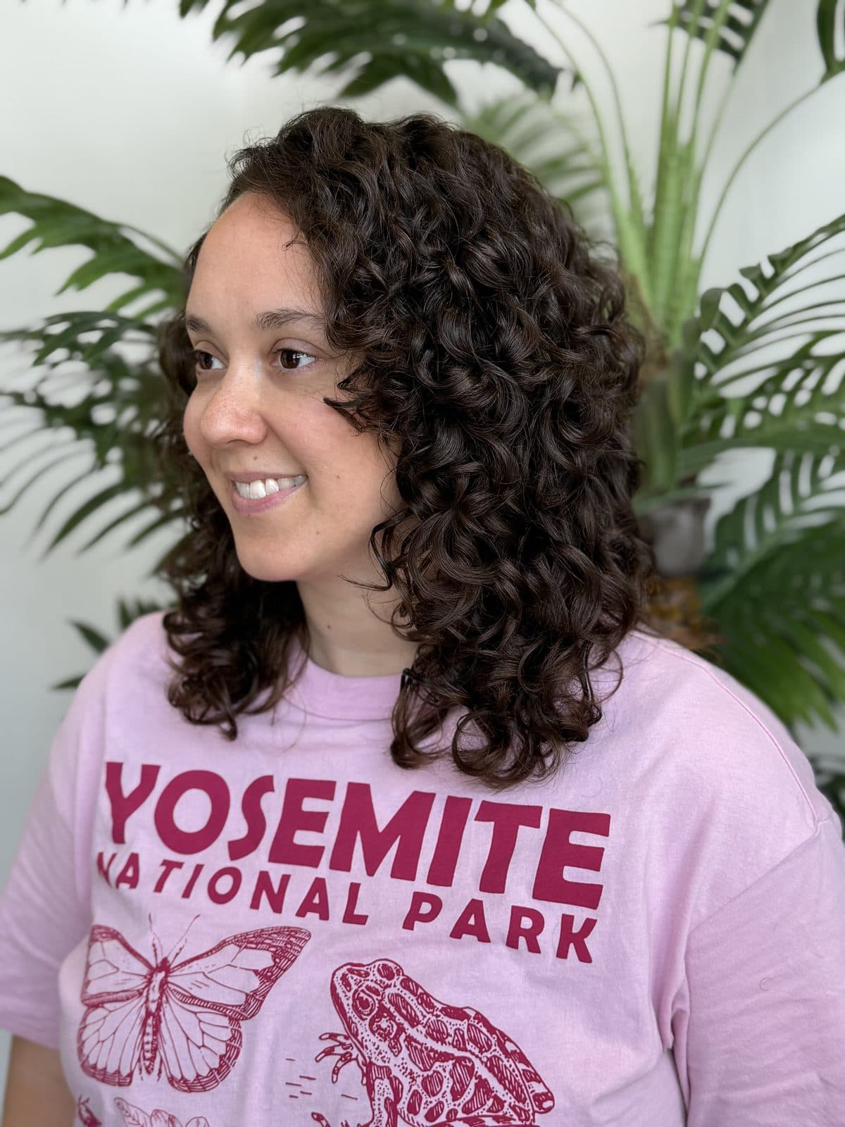 Client with a defined shoulder-length curly cut